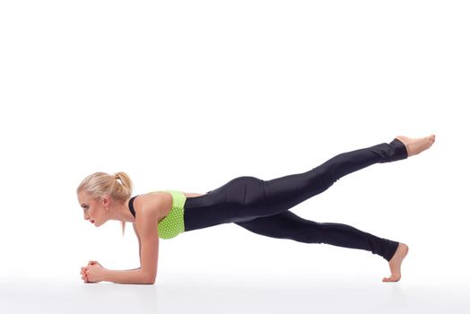 Core muscles burn. Studio shot of an attractive young blonde fitness woman working out doing planking exercise isolated copyspace gym fitness strength beauty body concept