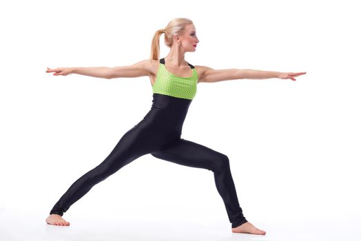 Calm and peace. Studio shot of a fit and healthy woman doing yoga standing in a warrior position exercising isolated on white copyspace