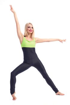 Exercising gracefully. Portrait of a gorgeous happy fitness woman exercising at the studio smiling to the camera isolated sports health beauty lifestyle concept