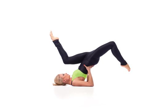 Improve your life through fitness. Horizontal studio shot of a gorgeous sporty woman doing a shoulder stand posing gracefully isolated copyspace