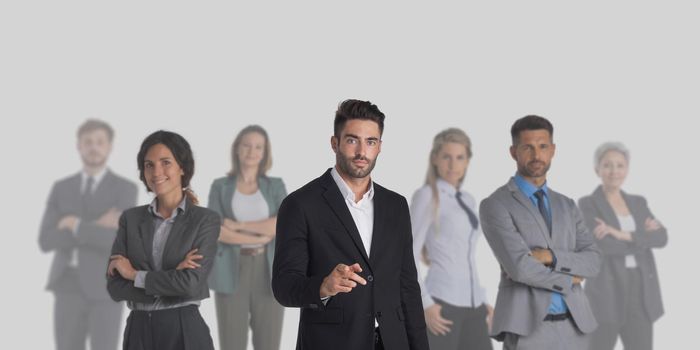 Group of business people standing together on gray background with copy space, unity cooperation teamwork concept