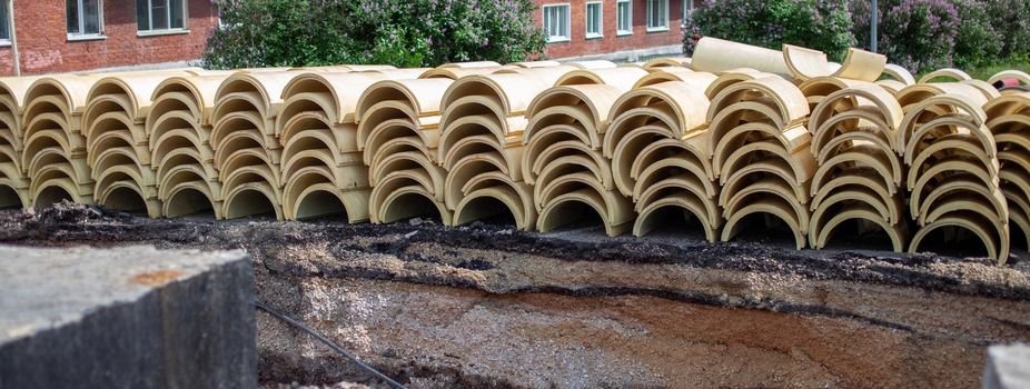 Round insulation for thermal insulation of heating pipes. Repair work in the city, the road is dug up, the insulation is on the surface, replacement of pipes, preparation for the heating season.