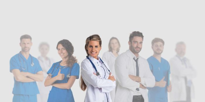 Team portrait of medical workers, doctors, nurses on gray background
