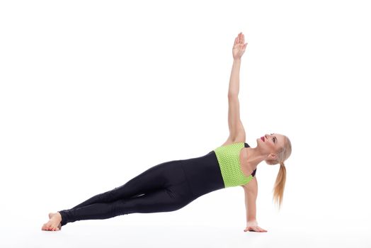 Better living through sports. Beautiful blonde female practicing yoga isolated on white yoga sports fitness life health concept