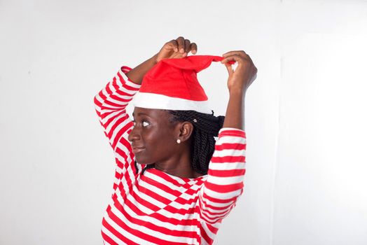 portrait of young woman wearing a Santa Claus hat.