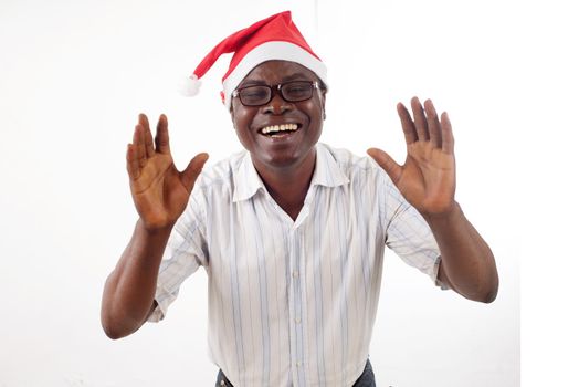 portrait of a happy man standing arms in front, wearing a Santa Claus hat isolated on a white background.