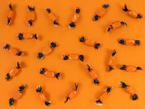 Halloween flat lay from orange and black candies.