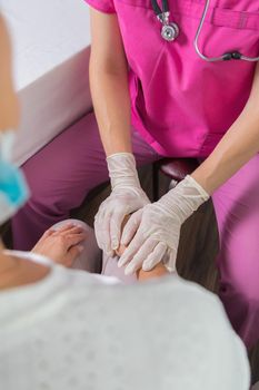 The girl the doctor reassures the woman about a good examination. The girl doctor smiles amiably at the patient. Health and medicine concept.