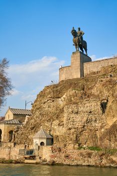 Metekhi church and the equestrian statue of King Vakhtang Gorgasali in Tbilisi. Tbilisi, Georgia - 03.17.2021