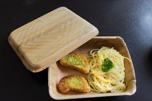 Spaghetti Pork Tomato Sauce with a slice of garlic baguette