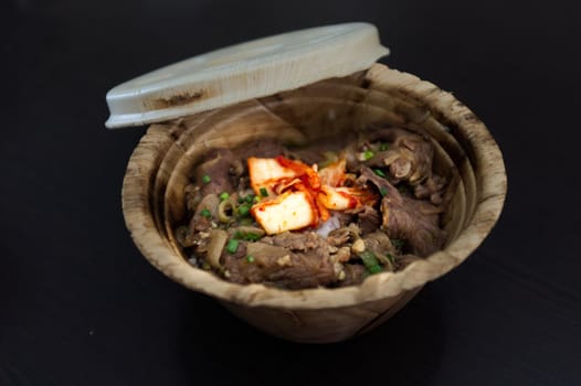 Japanese Gyudon with egg or Japanese beef bowl with egg in organic banan leaf bowl