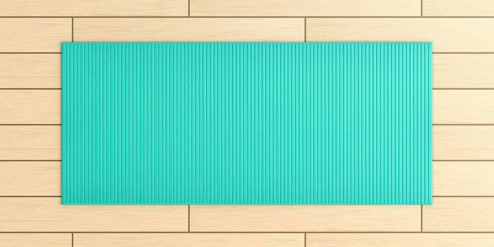 Top view of yoga mat on wood floor