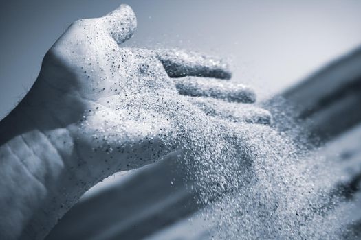 Sand flowing through the hand. Summer beach holiday vacation concept