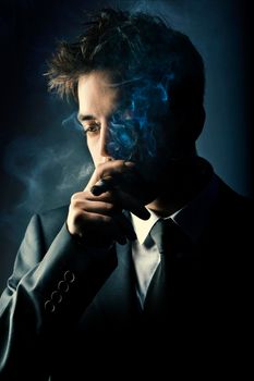 Young handsome stylish man smoking cigar, Fashion portrait