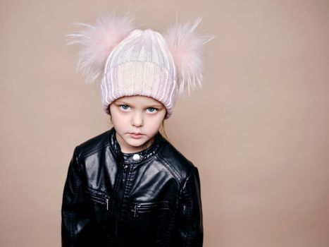 Portrait of beautiful little girl with wool hat and leather jacket