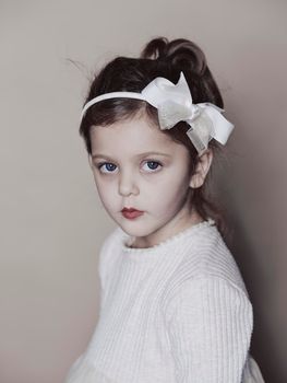 Portrait of little girl isolated on grey studio background