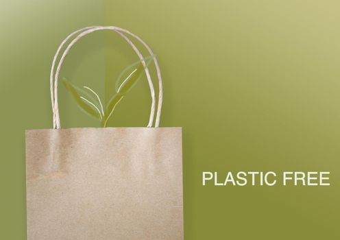 Eco paper bag with drawing plants on green background with wording plastic free