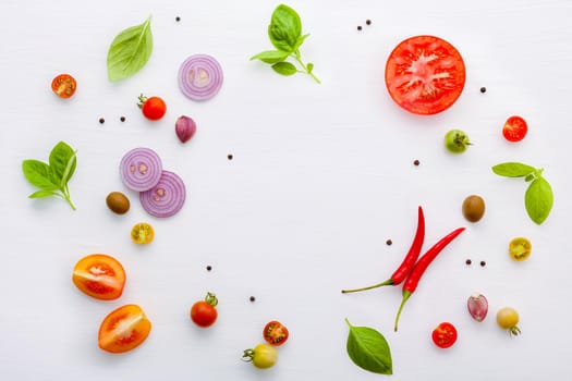 The ingredients for homemade pizza on white wooden background.