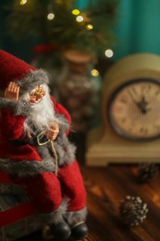 Toy Santa Claus sitting with gifts and Christmas decorations. Happy New Year coming