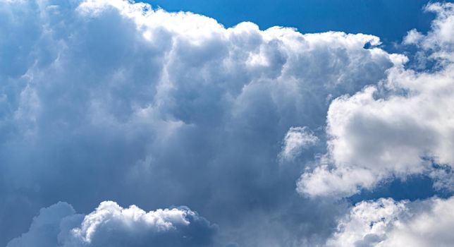 Massive cumulus cloud formation at the bright blue sky, soft fluffy background