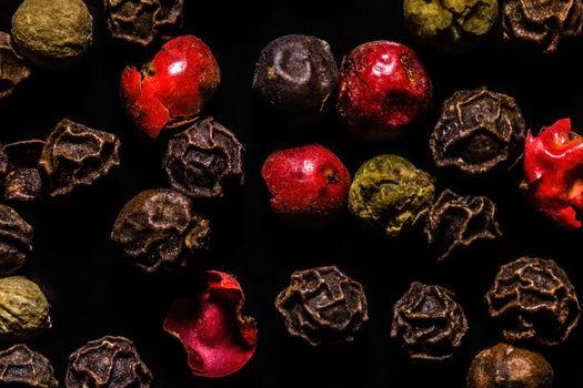 Colored dried pepper mix on a dark background, macro, close-up