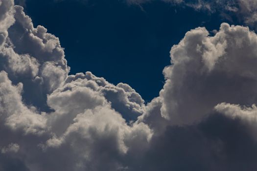 Huge cumulonimbus high in the deep blue sky