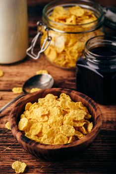 Breakfast with corn flakes, milk and berry jam