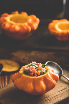 Raw pattypan squash stuffed with ground meat, carrot and leek on cutting board