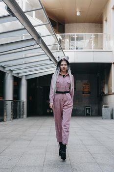 Beautiful cool girl with dreadlocks full length. Photo in the city - urban style