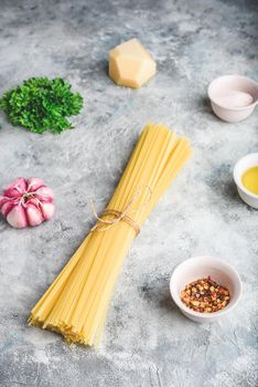 Raw ingredients for cooking linguine with olive oil, garlic and parsley