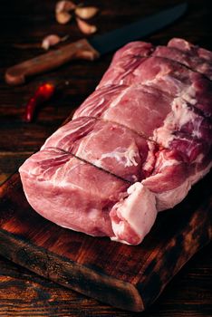 Pork loin joint on cutting board with spices