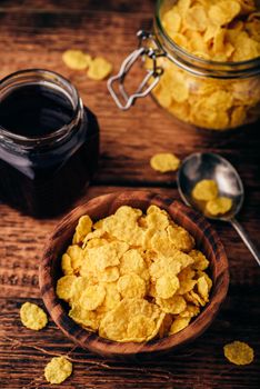 Breakfast with corn flakes, milk and berry jam