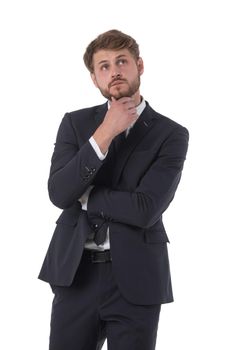 Thinking man isolated on white background. Portrait of serious young pensive businessman looking up at copyspace. Caucasian male model.