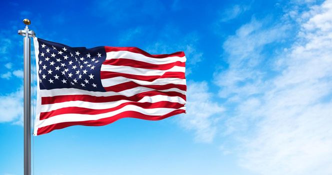 The national flag of the United States of America waving in the wind. Clear sky in the background. Selective focus. Democracy, independence and election day. Patriotic symbol of American pride