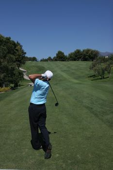 man golf swing on a golf course