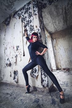 girl model in black with pink hair in an abandoned building