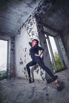 girl model in black with pink hair in an abandoned building