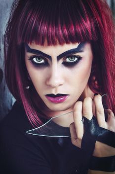 girl model in black with pink hair in an abandoned building