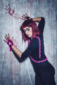 girl model in black with pink hair in an abandoned building