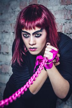 girl model in black with pink hair in an abandoned building