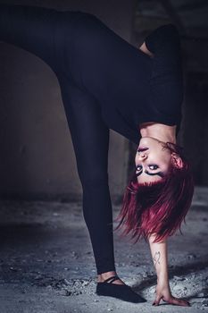 girl model in black with pink hair in an abandoned building