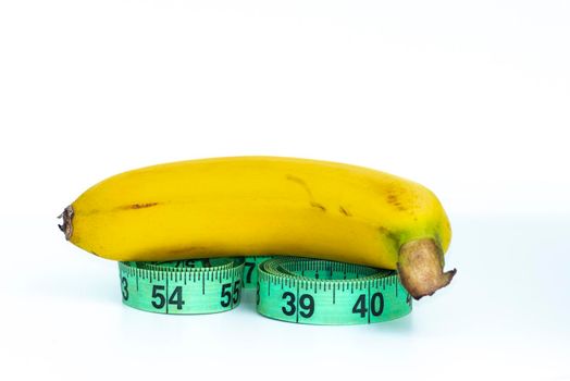 Banana with measuring tape isolated on white - Diet concept