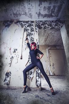 girl model in black with pink hair in an abandoned building