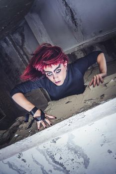 girl model in black with pink hair in an abandoned building