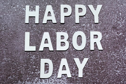 Happy labor day text on grunge grey concrete background