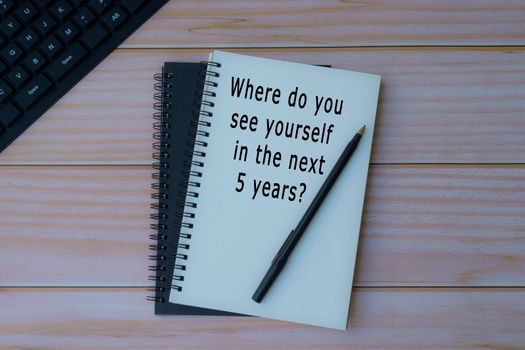 Text written on notepad. Where do you see yourself in the next 5 years