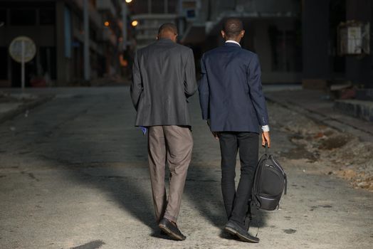 Young business men with suit walking in the city at night after work