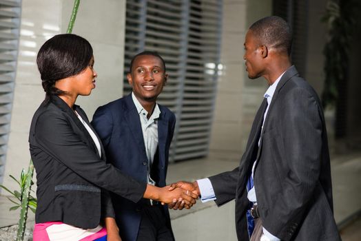 Small group of business people greeting each other while making friends outside.