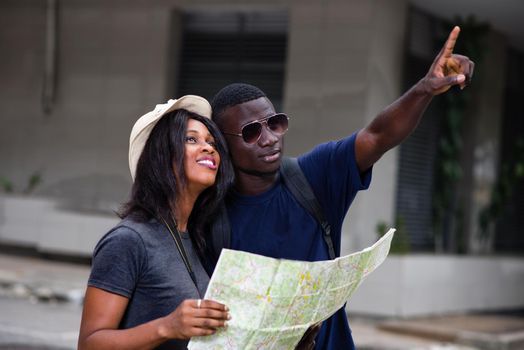 Tourist couple traveling and using the map. man points to a place to explore
