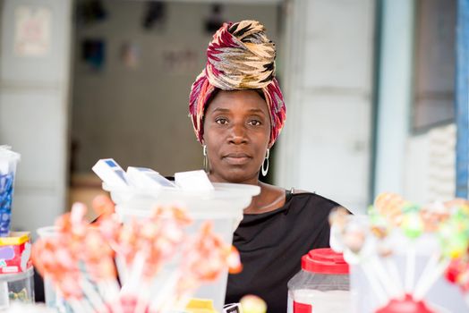 Saleswoman behind handy stand.